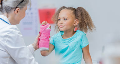 Girl being examined for a broken bone.